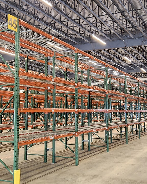 rows of pallet racks installed in a big warehouse